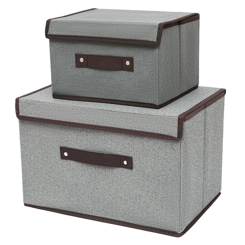 Two gray storage boxes with brown handles on a white background