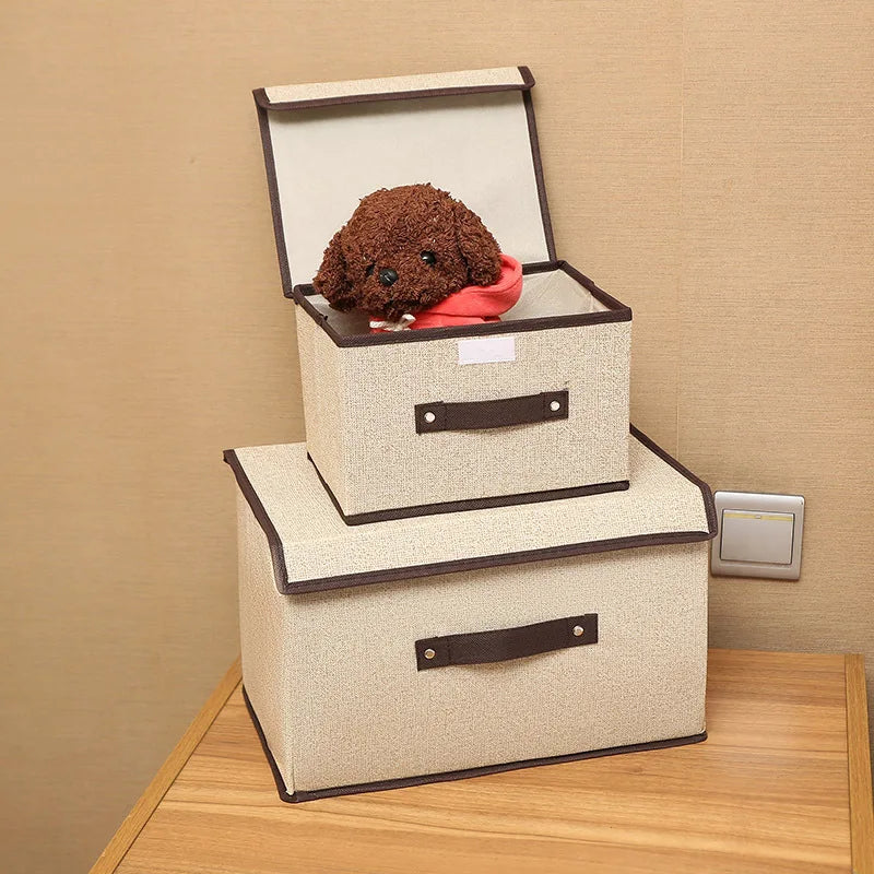 Two storage boxes with a plush brown dog toy inside on a wooden surface.
