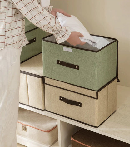 Person organizing storage boxes on a shelf