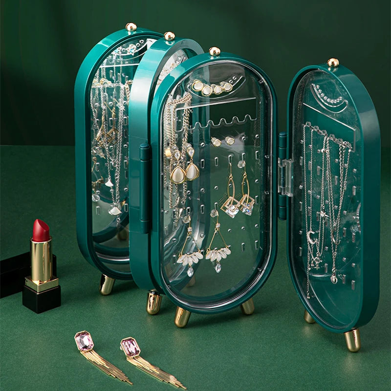 Green jewelry organizer with necklaces, earrings, and a lipstick on a green background