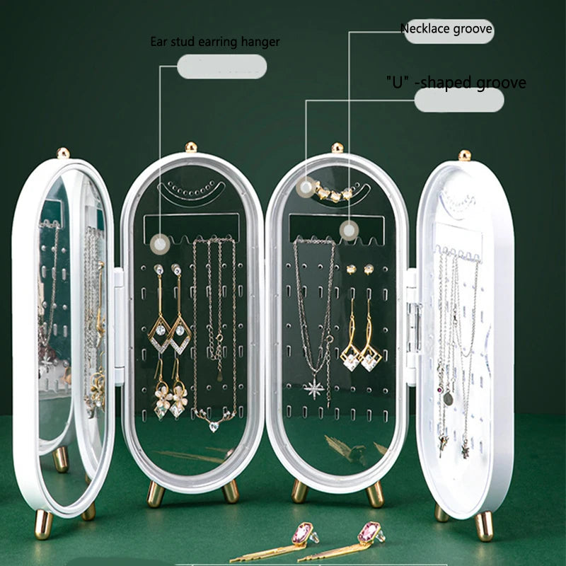 Jewelry organizer with mirror and various jewelry items on a green background