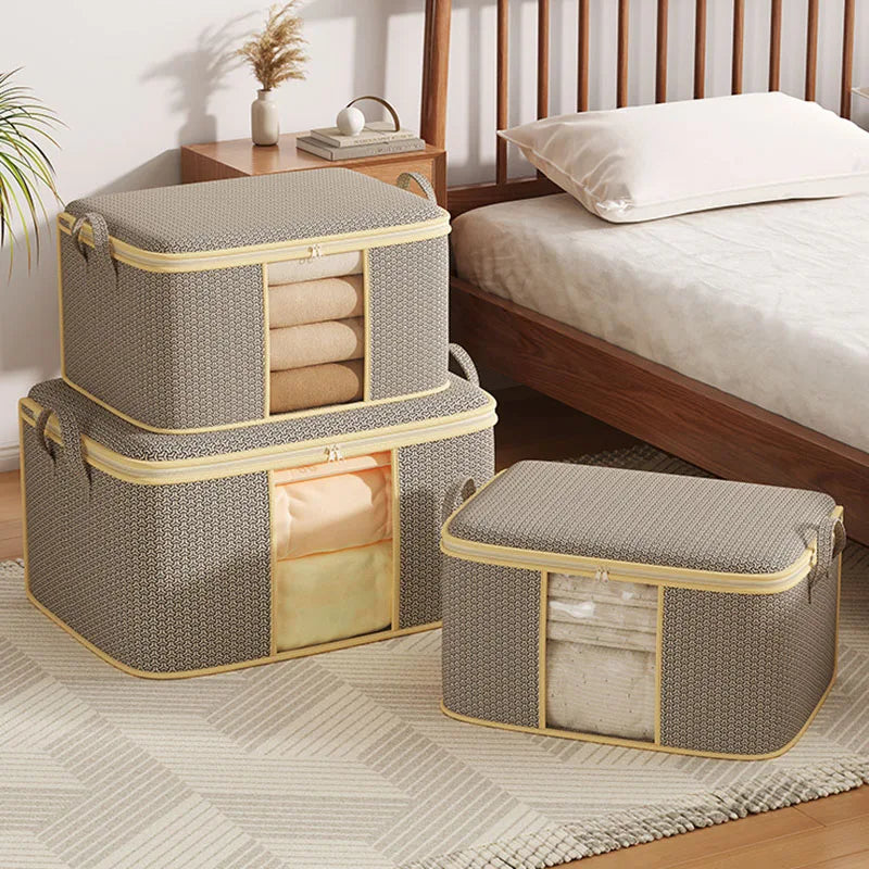 Set of three gray storage boxes with yellow zippers on a bedroom floor.