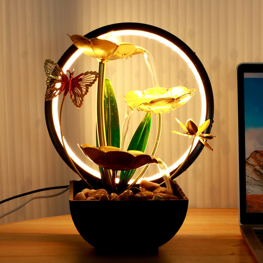 Decorative lamp with flowers and butterflies on a wooden surface.