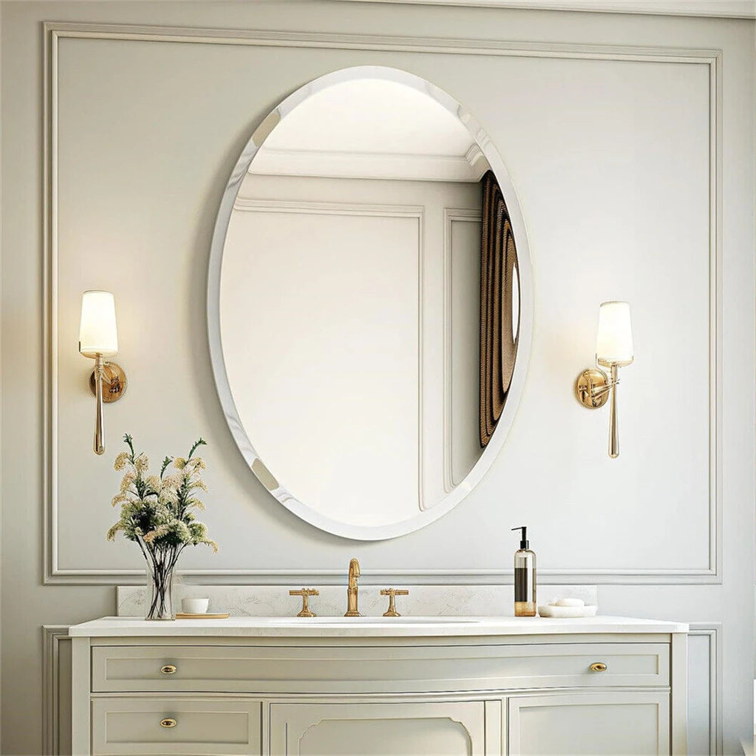Bathroom vanity with oval mirror, lights, and decorative elements.