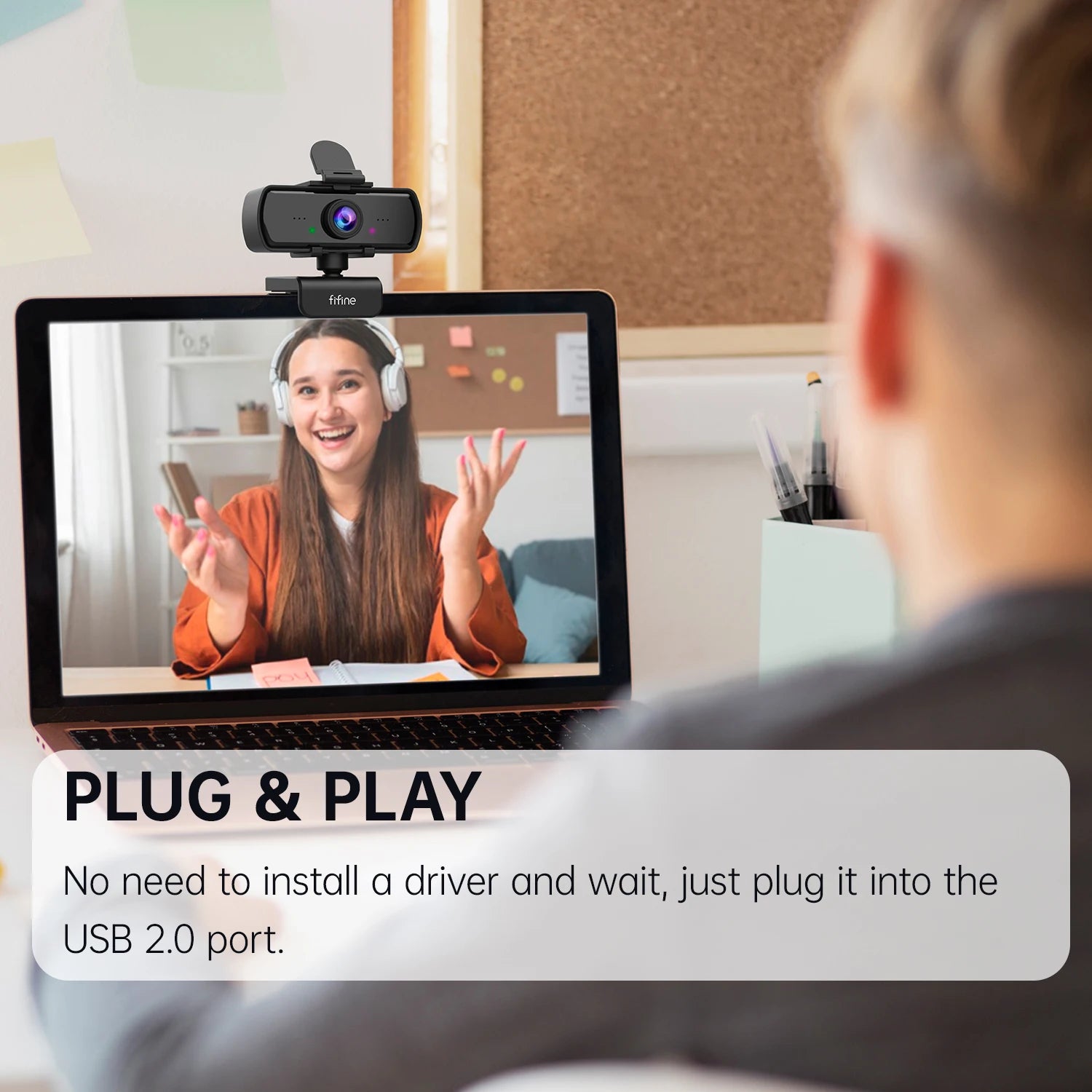 Person using a laptop with a webcam, showing a video call with another person.