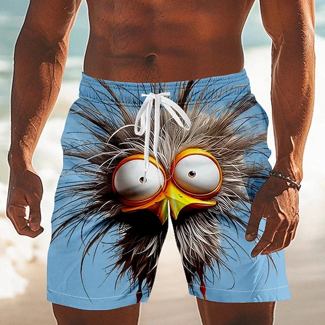 Person wearing blue beach shorts with a cartoonish face design on a beach.