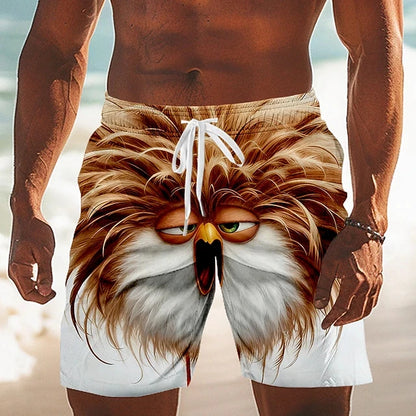 Beach shorts with an eagle design worn by a person on a beach.