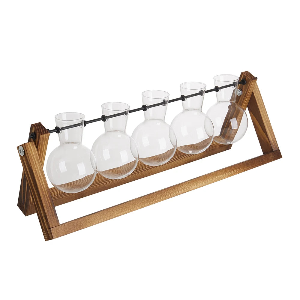 Wooden stand with five glass carafes on a white background