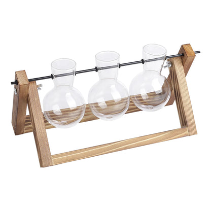 Three glass bulbs on a wooden stand with a white background