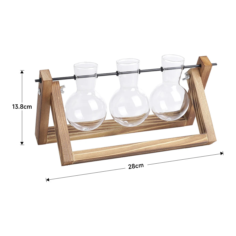 Three glass carafes on a wooden stand with measurements indicated.