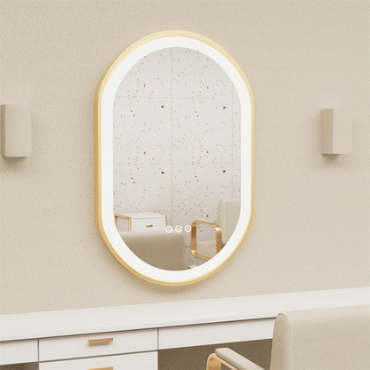 Oval-shaped mirror with gold frame on a beige wall