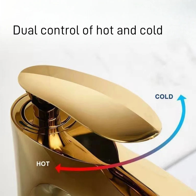 Gold faucet with labels for hot and cold water on a white background