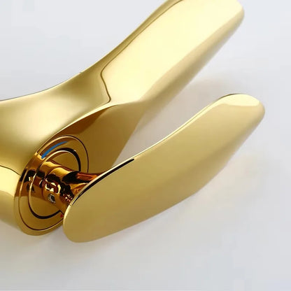 Gold door handle on a white background