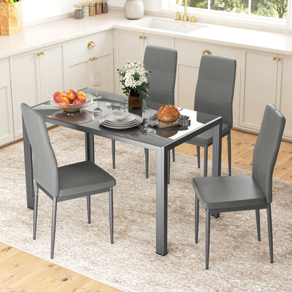 Dining table set with four gray chairs in a kitchen.