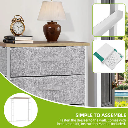 Gray textured dresser with wooden top, lamp, clock, and books on a white wall.