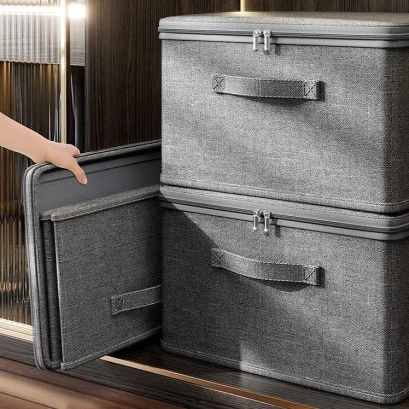 Gray storage box with open lid on a wooden surface