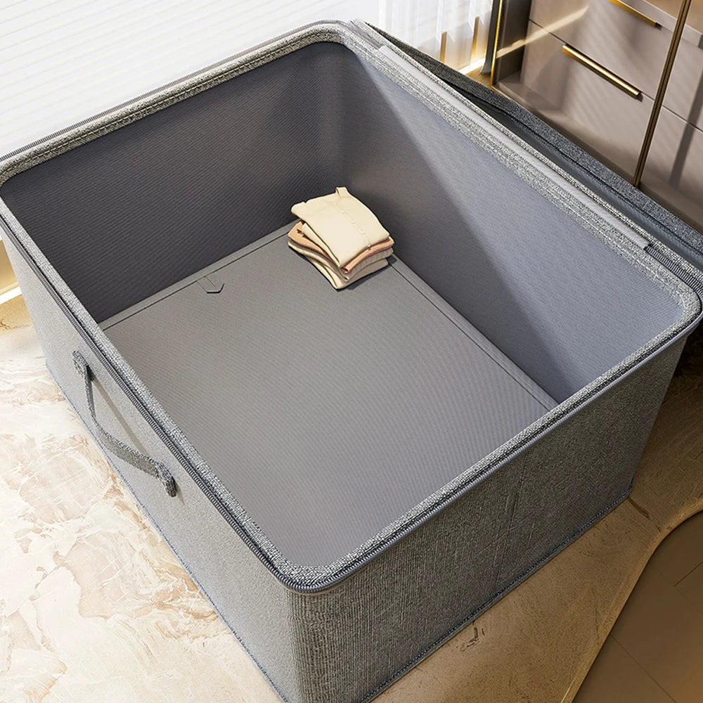 Gray storage bin with folded beige cloth on a light wooden floor.