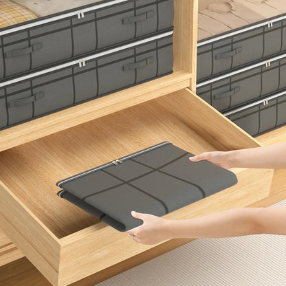 Person placing a gray storage bin into a wooden shelf.