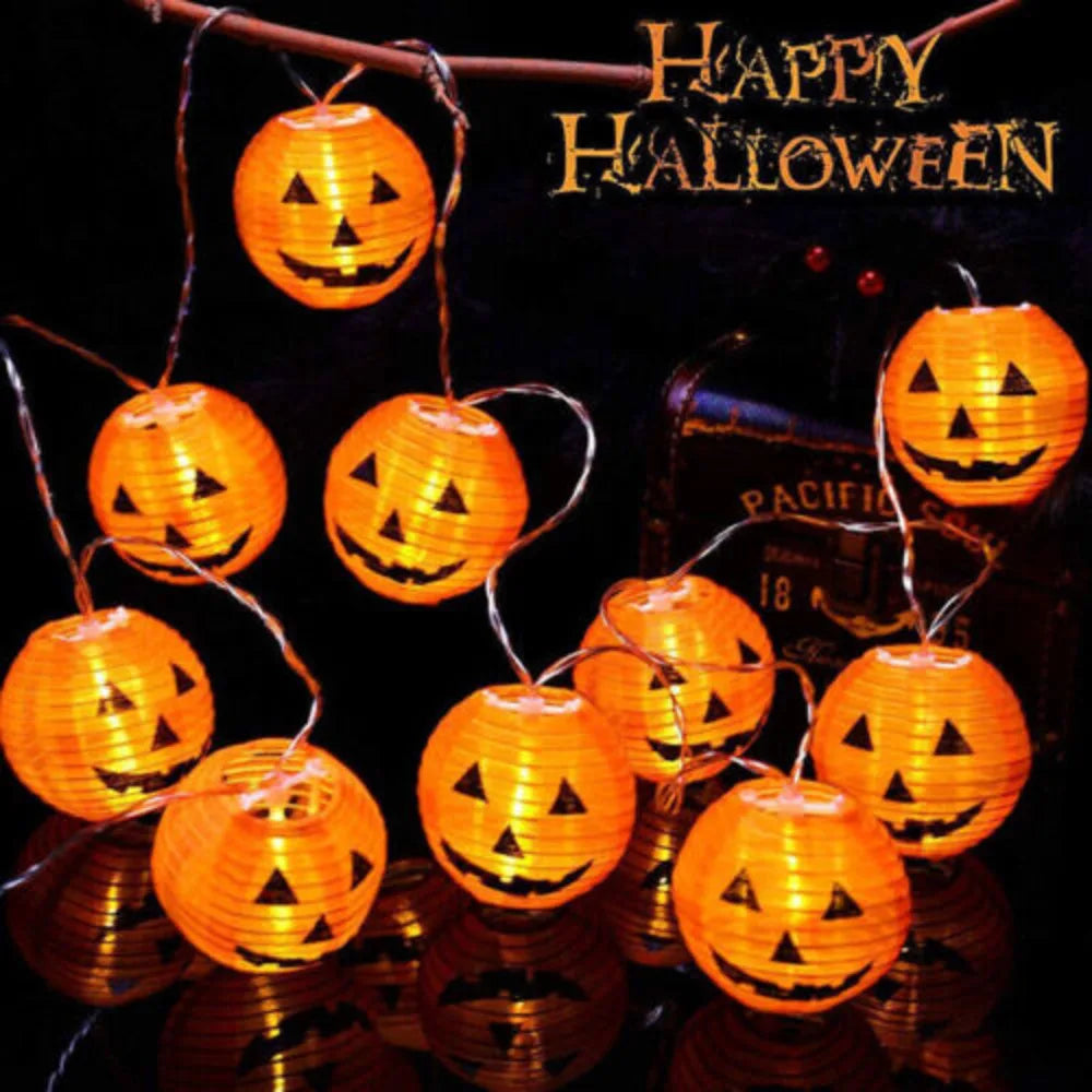 String of pumpkin-shaped lights with 'Happy Halloween' text on a dark background