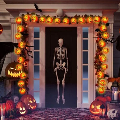 Halloween-themed door with jack-o'-lanterns and a skeleton