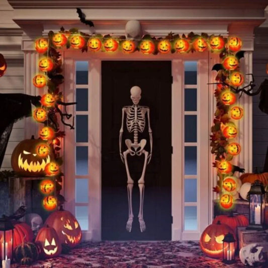 Halloween-themed door with jack-o'-lanterns and a skeleton