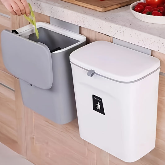 Kitchen trash bins with one being opened to dispose of waste.