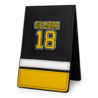 Black and yellow card holder with 'Gilmore' and number '18'