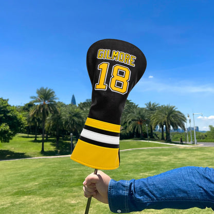 Golf club head cover with 'Gilmore 18' on a golf course