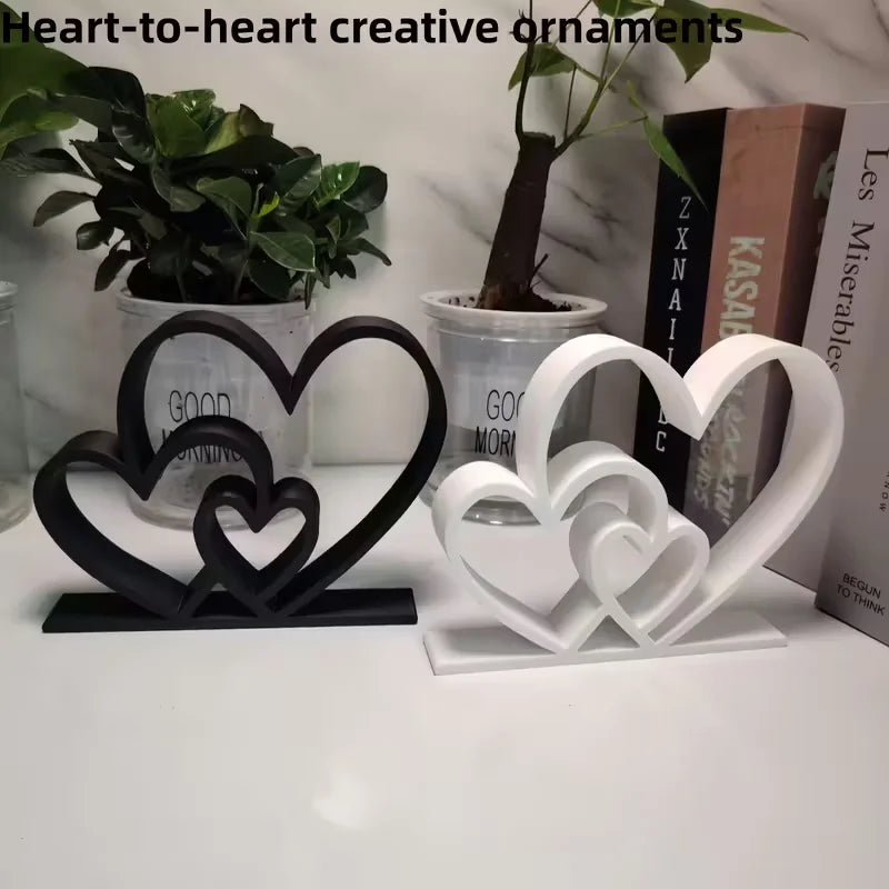 Heart-shaped decorative ornaments on a white surface with books and plants in the background.