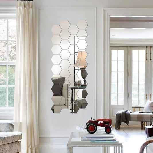 Hexagonal mirror on a wall in a living room with a red toy tractor and books on a table.