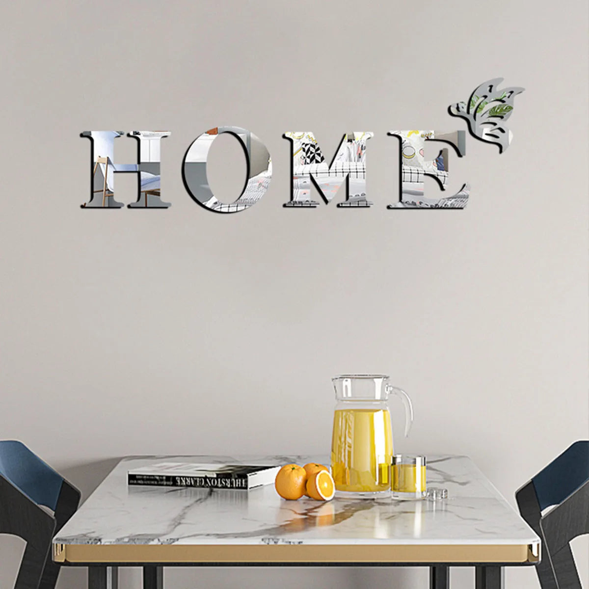 Decorative 'HOME' wall letters on a neutral wall with a table and chairs below.