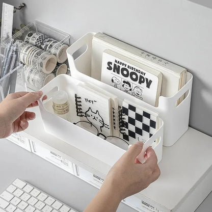 White storage bins with stationery items on a desk
