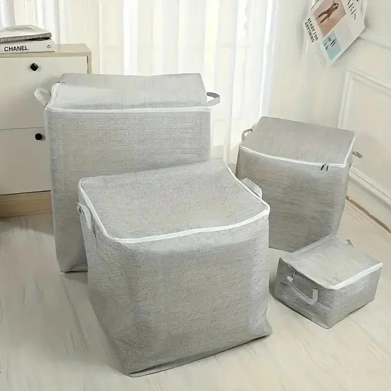 Set of gray laundry baskets on a light wooden floor.