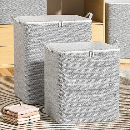Two gray herringbone-patterned laundry baskets on a wooden floor.