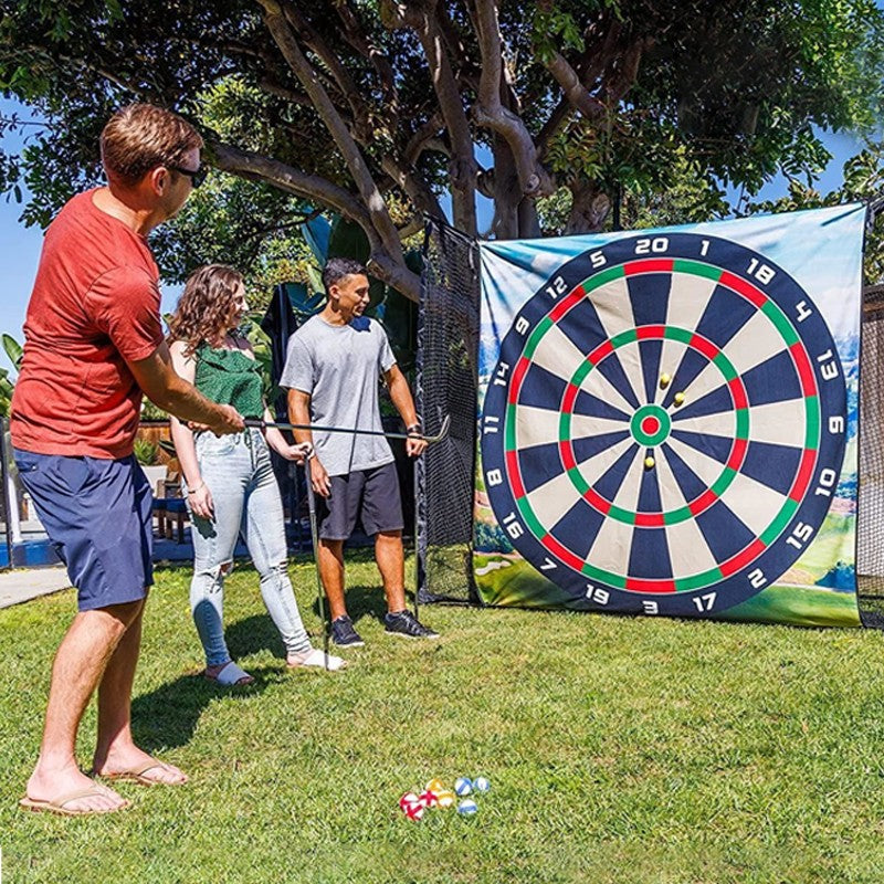 People playing darts outdoors with a large dartboard in the background
