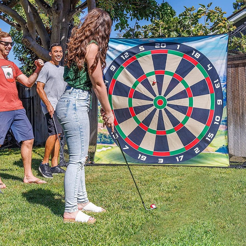 People playing with a large outdoor dartboard in a backyard setting.
