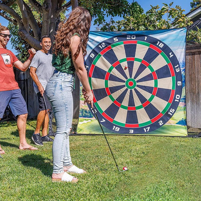 People playing with a large outdoor dartboard in a backyard setting.