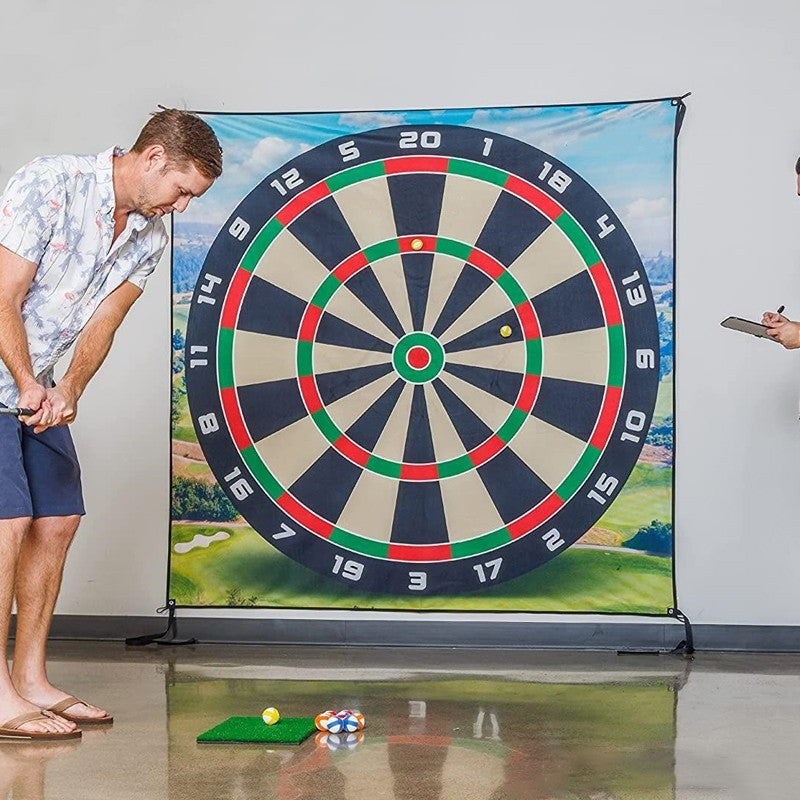 Man playing darts with a large dartboard in an indoor setting