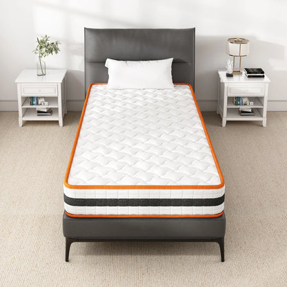 Mattress on a bed in a bedroom setting with white walls and furniture.