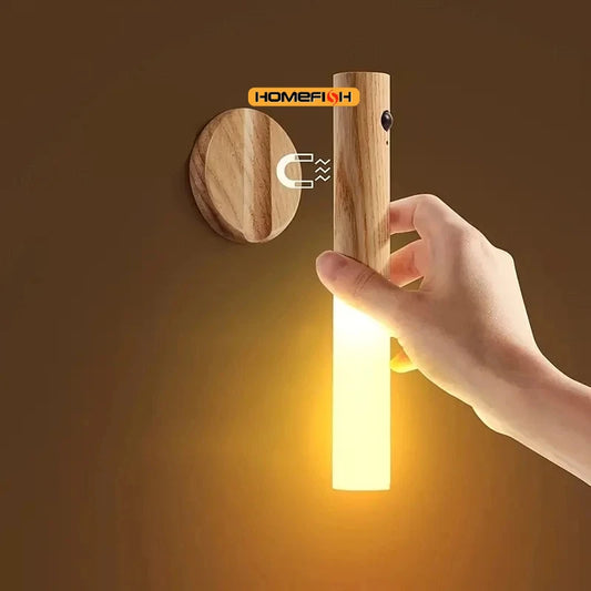 Hand turning on a wooden wall light fixture with 'Homefish' branding.