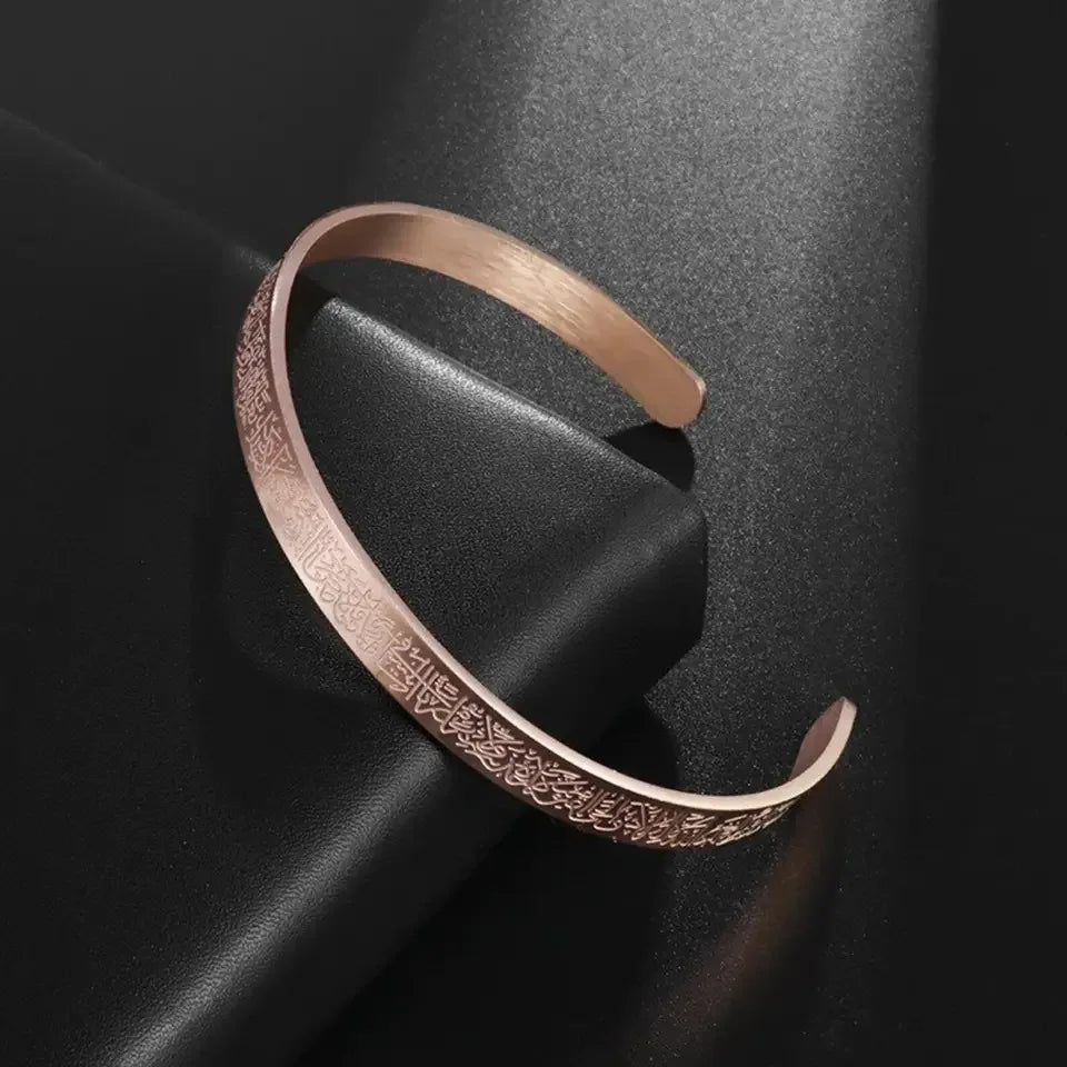 Rose gold bracelet with intricate design on a dark surface