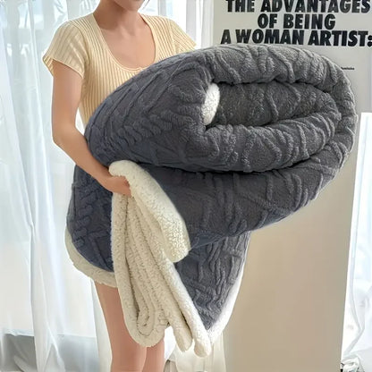Person holding a textured gray and white blanket indoors.