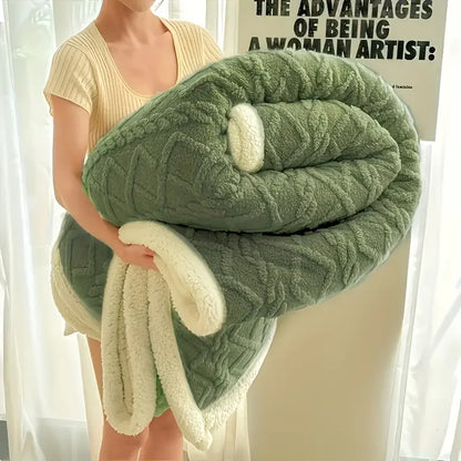 Person holding a green and white textured blanket with a blurred poster in the background