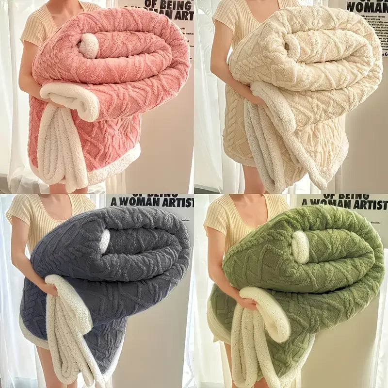 Four different colored textured blankets held by a person against a neutral background.