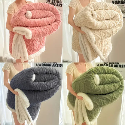 Four different colored textured blankets held by a person against a neutral background.