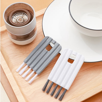 Set of gray and white straws on a wooden tray with a ceramic cup and saucer in the background.
