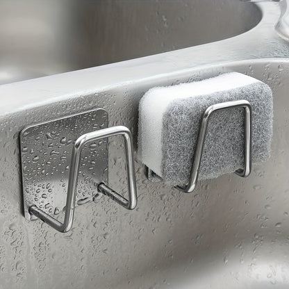 Metal hooks with a sponge on a kitchen sink