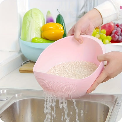 Person washing rice in a pink colander over a sink with fruits and vegetables in the background.