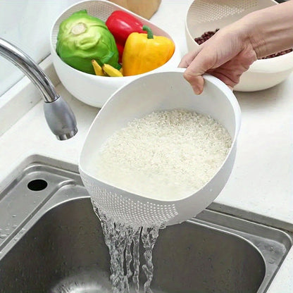 Person rinsing rice in a white colander over a sink with colorful vegetables in the background.