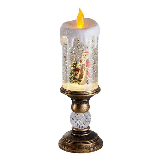 Decorative candle with Santa Claus and a tree inside a snow globe on a white background